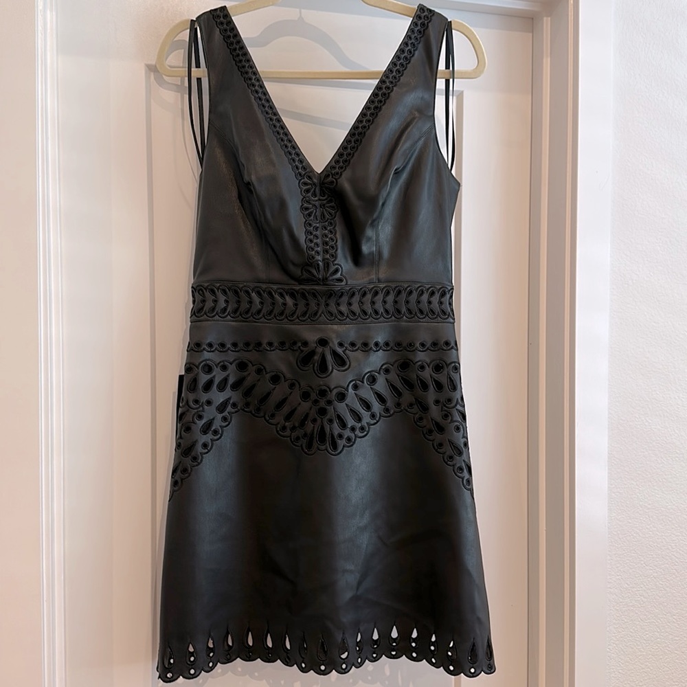 BEBE laser cut embroidered faux leather mini dress